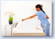 Hospital staff making bed