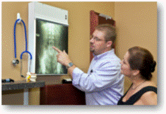 Doctor pointing at x-ray of spine