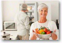 Senior woman with colander of vegetables