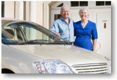 Senior couple standing by car